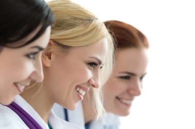 Three female doctors looking at monitor 