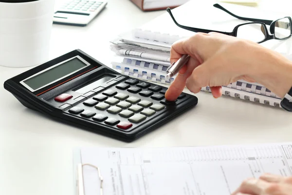 Close up of female accountant or banker making calculations — Stock Photo, Image