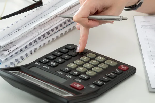 Close up of female accountant or banker making calculations — Stock Photo, Image