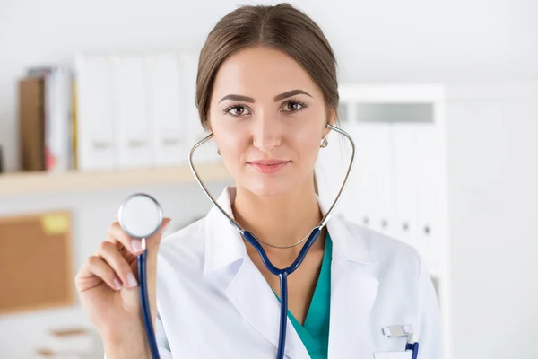 Portrait of beautiful female doctor holding stethoscope head — Stok fotoğraf