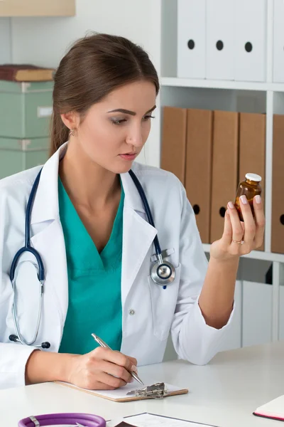 Medicina feminina médico segurando frasco com pílulas e escrita pré Imagem De Stock