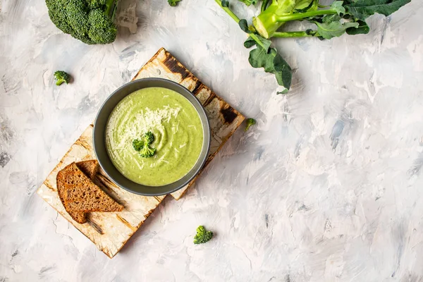 Delicious broccoli cream soup with parmesan cheese and crunchy croutons on white background. Healthy vegetarian food. Vegan menu. Top view, copy space. — Stock Image Delicious Broccoli Cream Soup Parmesan Cheese Crunchy Croutons White Background Royalty Free Stock Photos