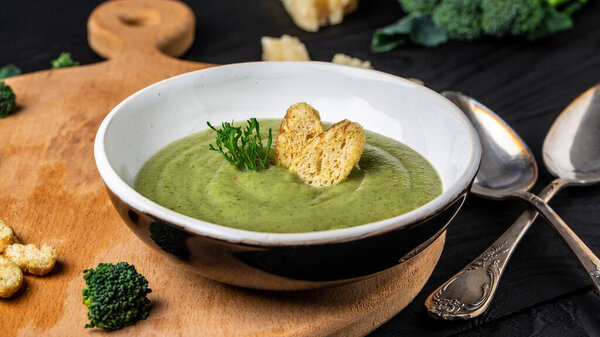 Delicious broccoli cream soup. Healthy vegetarian food. Vegan menu. Food recipe background. Close up.