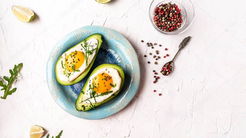 Homemade Organic Egg Baked in Avocado with Salt and Pepper. Avocado stuffed with eggs. Delicious breakfast or snack. top view.