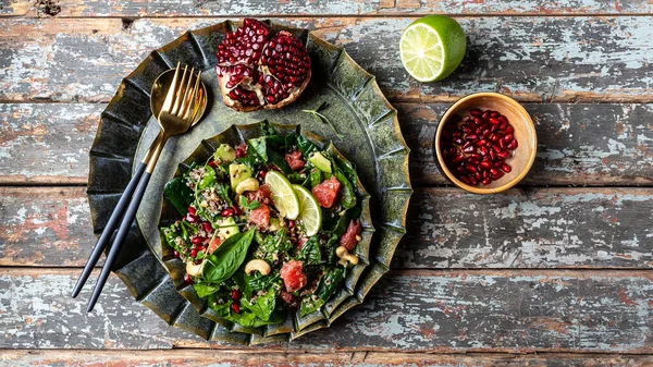 trendy brunch Winter Salad with quinoa, spinach, avocado, grapefruit, pomegranate, nuts and microgreens, banner, catering menu recipe place for text, top view.