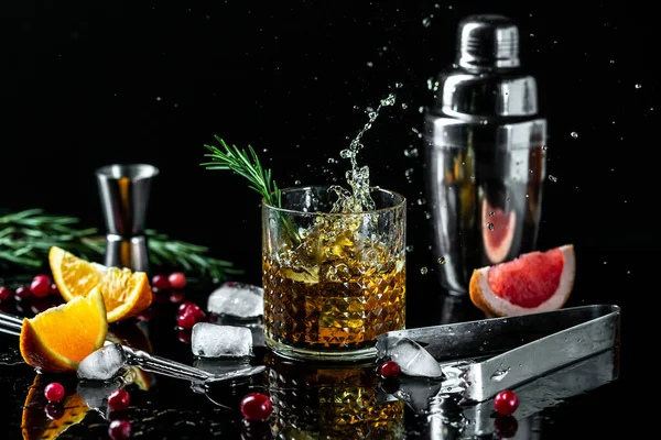 shot of whiskey with splash on black background. banner, menu, recipe, place for text.