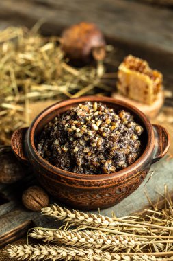 Geleneksel Noel Slav yemeği kutia ahşap masada servis edilir. Ukrayna 'da tatlı bir Noel yemeği, fındıklı, haşhaş tohumlu ve kuru üzümlü, dikey görüntü.