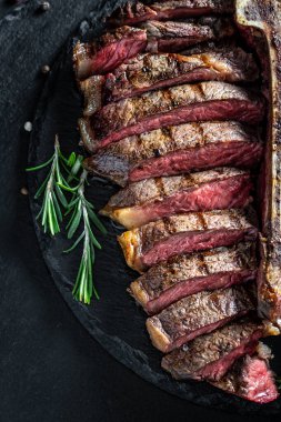 Baharatlı biftekli ızgara wagyu bifteği, slate tahtasının üst görüntüsü olarak dilimlenmiş biftek, biftek sulu biftek ve az pişmiş baharat. Yemek tarifi geçmişi. Kapatın. dikey resim.