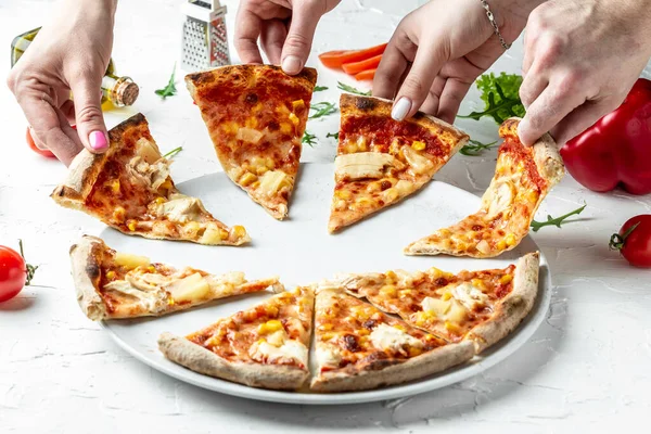 hands of colleague or friends eating pizza, party at home, eating pizza and having fun. People Hands Taking Slices Of Pizza. leisure, food holidays concept.