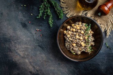 Buda yayı, kinoa salatası, nohut ve kekik. Koyu arkaplanda süper yemek, üst görünüm.