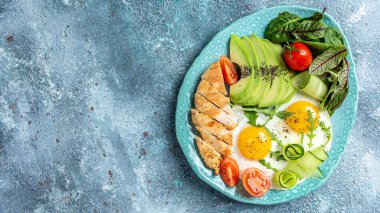 Kahvaltı. Tavuk ızgara fileto salata taze domates, salatalık, yumurta ve avokado. Sağlıklı yiyecekler, ketojenik diyet, diyet öğle yemeği konsepti. metin için yer, üst görünüm.