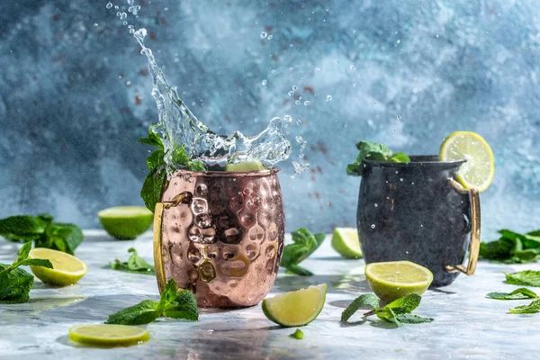 Icy cold moscow mules with ginger beer and vodka. splashes frozen motion. banner, menu, recipe, place for text.