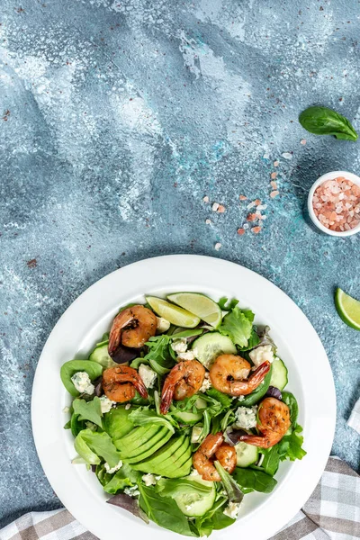 Seafood salad with avocado, blue cheese and smoked shrimps. Healthy food. vertical image, place for text.