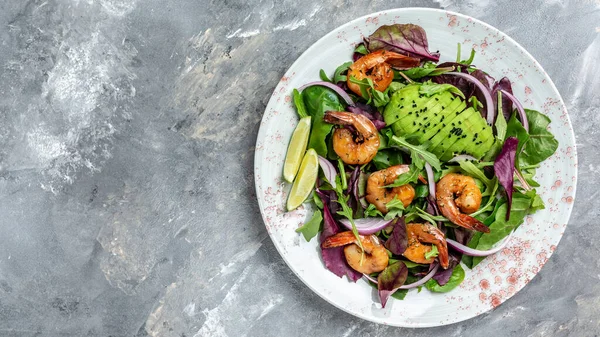 Vegan vegetarian dinner background. Green salad with avocado, blue cheese and smoked shrimps. Healthy eating concept. Detox diet. Vegetarian lunch. Weight loss. Cleanse program.