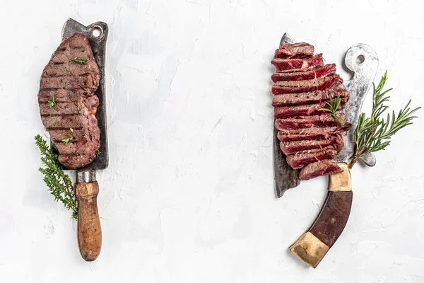 Fresh raw Prime Black Angus beef rump steak or top sirloin beef meat steak served on old meat butcher on light background, banner, menu recipe place for text, top view.