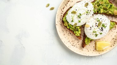 Avokado ve yumurtalı sandviç. Vejetaryen yemeklerle kahvaltı, sağlıklı beslenme konsepti. afiş, metin için menü tarifi yeri, üst görünüm.