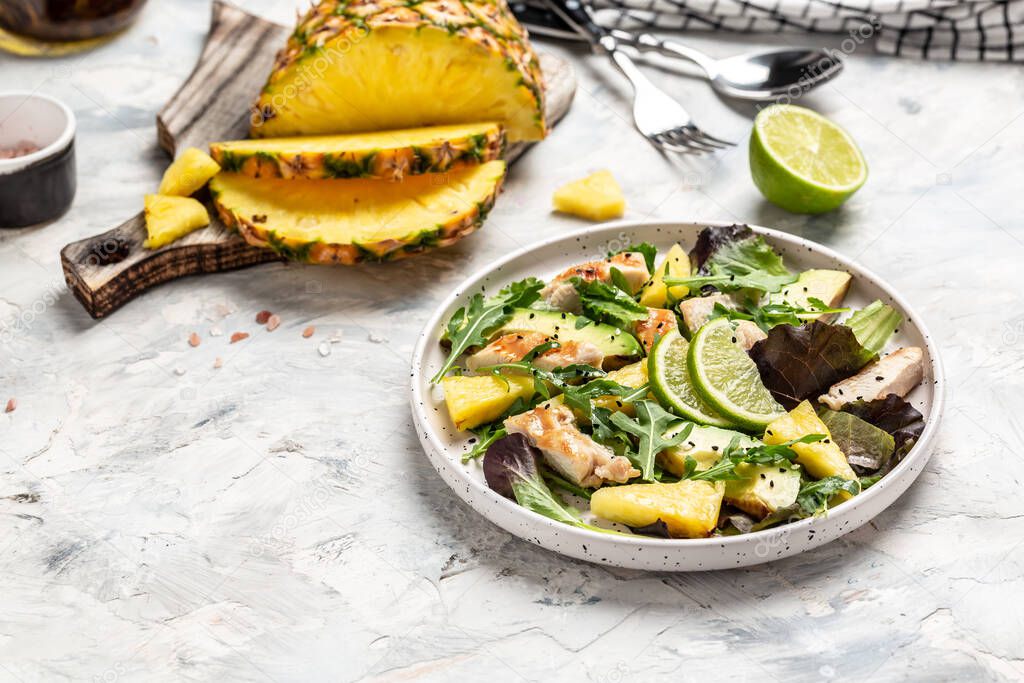 Healthy lunch with grilled chicken, fresh lettuce, pineapple, avocado salad. selection of healthy food.