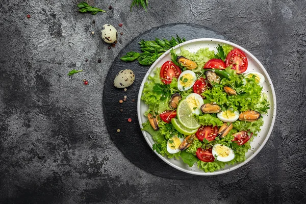 Salad with mussels, quail, egg, conjugate, lime, spinach, lettuce, cherry tomatoes and microgreen. Dietary salad. banner, menu recipe place for text top view.
