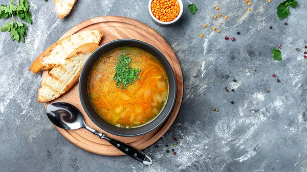 Curried red lentil soup, Traditional turkish or arabic lentil and vegetable spicy soup, healthy vegan food. Top view,