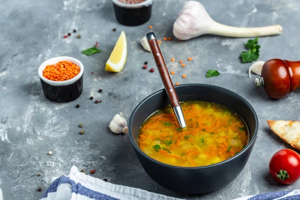 Curried red lentil soup, Traditional turkish or arabic lentil and vegetable spicy soup, healthy vegan food. Top view,