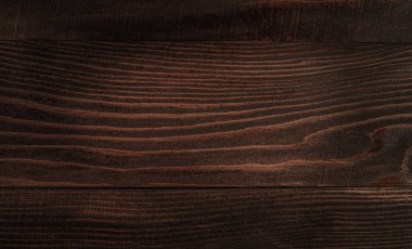 Dark rustic wooden background with natural texture and grain, copy space, top view.
