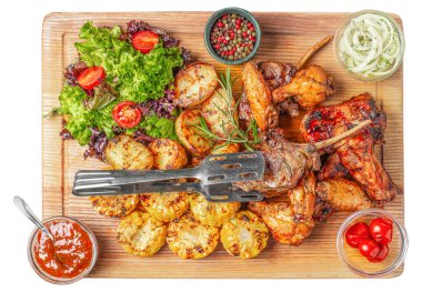 Grilled meat assortment with roasted vegetables, fresh salad, corn, sauces, and spices served on wooden board, top view rustic food composition ideal for restaurant advertising