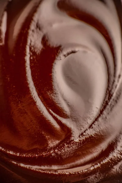 Yumuşak çikolata kremlerinin soyut makro dokusu, yiyecek markalaştırma, paketleme, reklam ve tasarım için zengin tatlı arkaplanı..