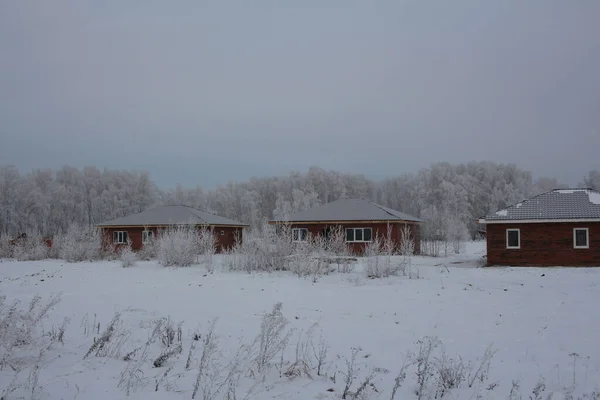 brick house in the snow construction of cottages in winter in Siberia