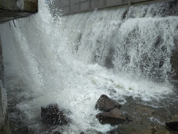 water flows down the waterfall in the basement of the dam flood accident