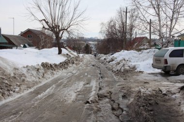 Kirli bir toprak yol ve patika köyde karla kaplı. Baharda geçit yok.