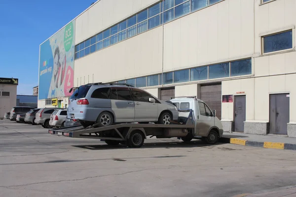 ロシア ノヴォシビルスク04 2021 壊れた車は駐車違反のための駐車場にレッカー車で連れ去られます — ストック写真