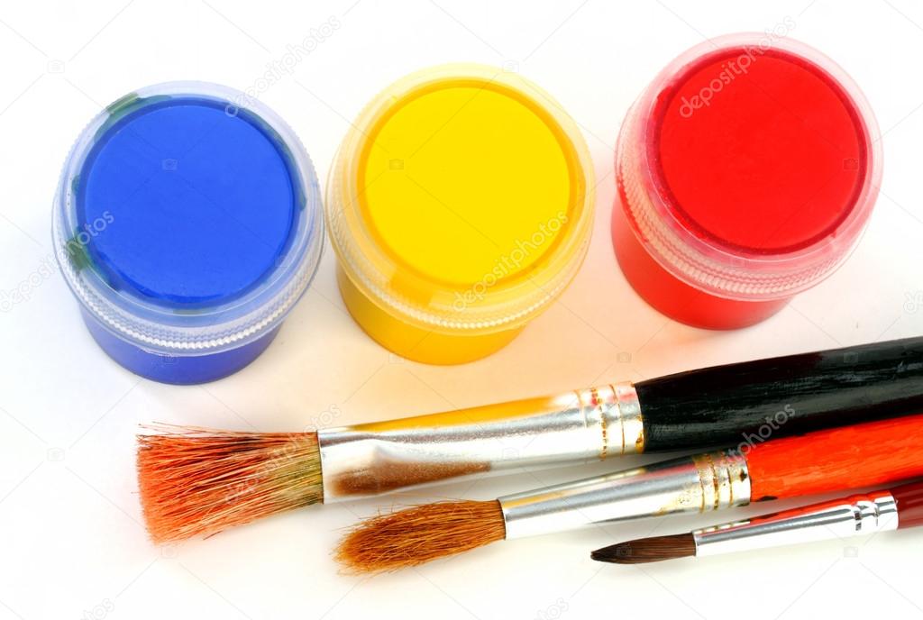 Multicolor children paints with brush on white background