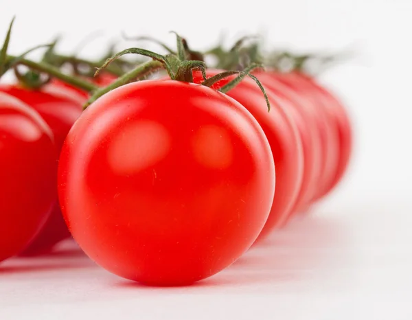 Juicy organic Cherry tomatoes with green leaf isolated over whit — Stock Photo, Image