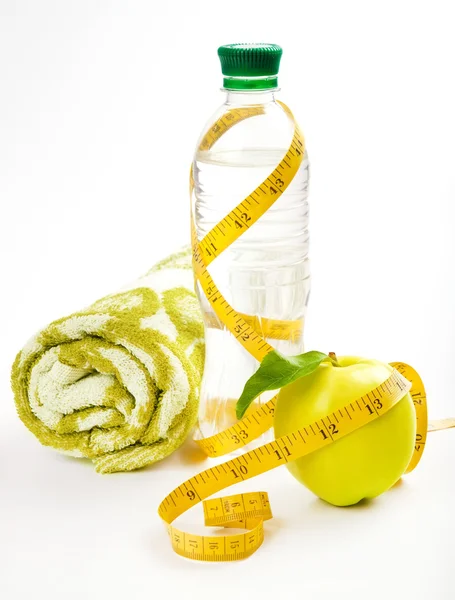 Apple core, bottled water for healthy life over a white background — Stock Photo, Image