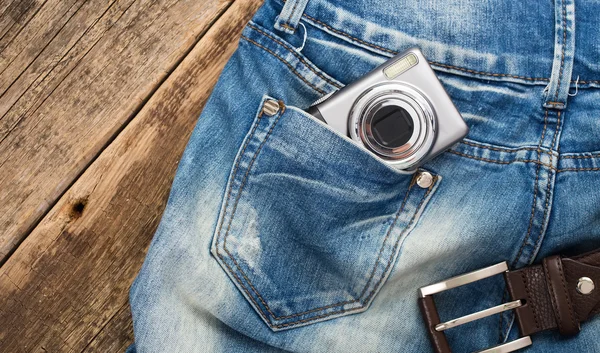 Unknown compact digital camera in pocket of jeans with belt on w — Stock Photo, Image