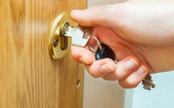 Locking up or unlocking door with key in hand — Stock Photo, Image