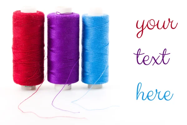 Pile of colored bobbins of lurex thread isolated on white — Stock Photo, Image