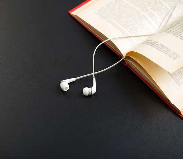 Books and ear plugs — Stock Photo, Image