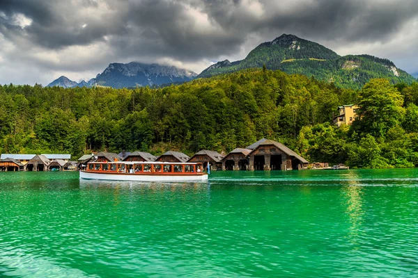 Wooden boathouses on the alpine lake and passenger boat,Germany — Stock Photo, Image