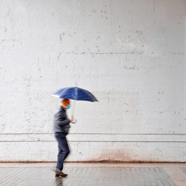 people with umbrella in rainy days in spring season, Bilbao city, Spain