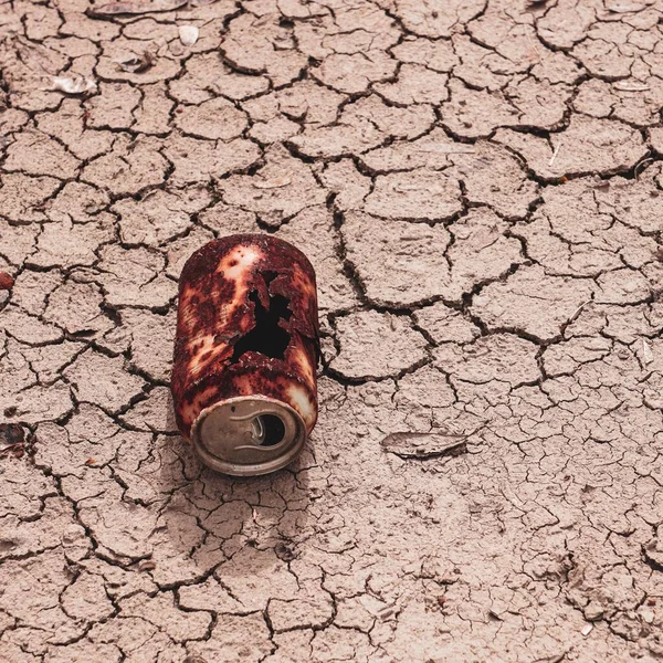 old rusty can on the desert ground, global warming