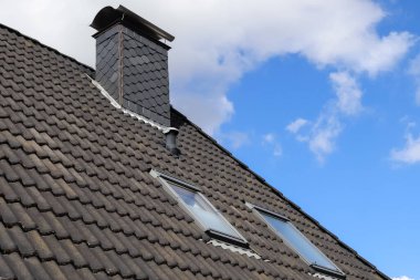 Siyah çatı kiremitleri ile Velux tarzı çatı penceresi