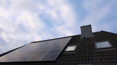 Photovoltaic panels installed on a residential roof. Sustainable technology producing alternative green electricity from the sun