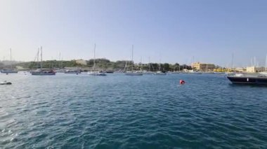 Gozo, Malta - 28. September 2024: Navigating through the clear blue waters of a marina in Gozo, Malta, on a sunny day