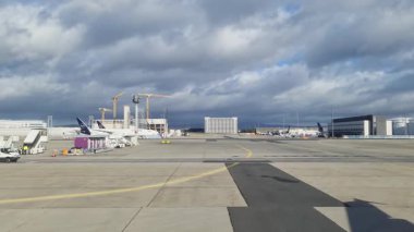 Valletta, Malta - 27. September 2024: View from a moving plane taxiing on the tarmac at Frankfurt Airport on a cloudy day