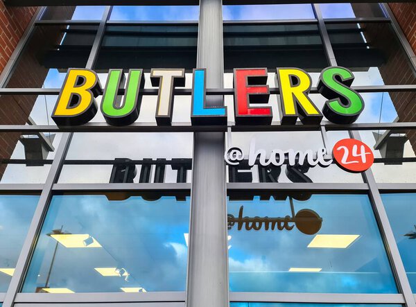 Kiel, Germany - 29. December 2025: Butlers and home24 brand signs displayed on a modern commercial building exterior