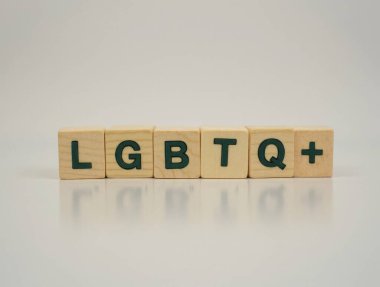 Lgbtq + beyaz parlak yüzeyde yansımalı ahşap küplerle yazıldı