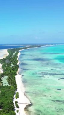 Temiz su ve el değmemiş plajları olan uzun, ince tropikal bir adanın nefes kesici manzarası.