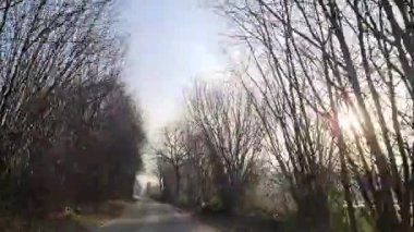 Uzak bir kırsal alanda kaygan ve karlı bir yolda araba sürerken ilk kişi görüntüsü