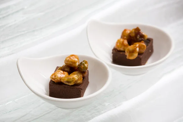 Close up of chocolate brownie topping with sweet nuts — Stock Photo, Image